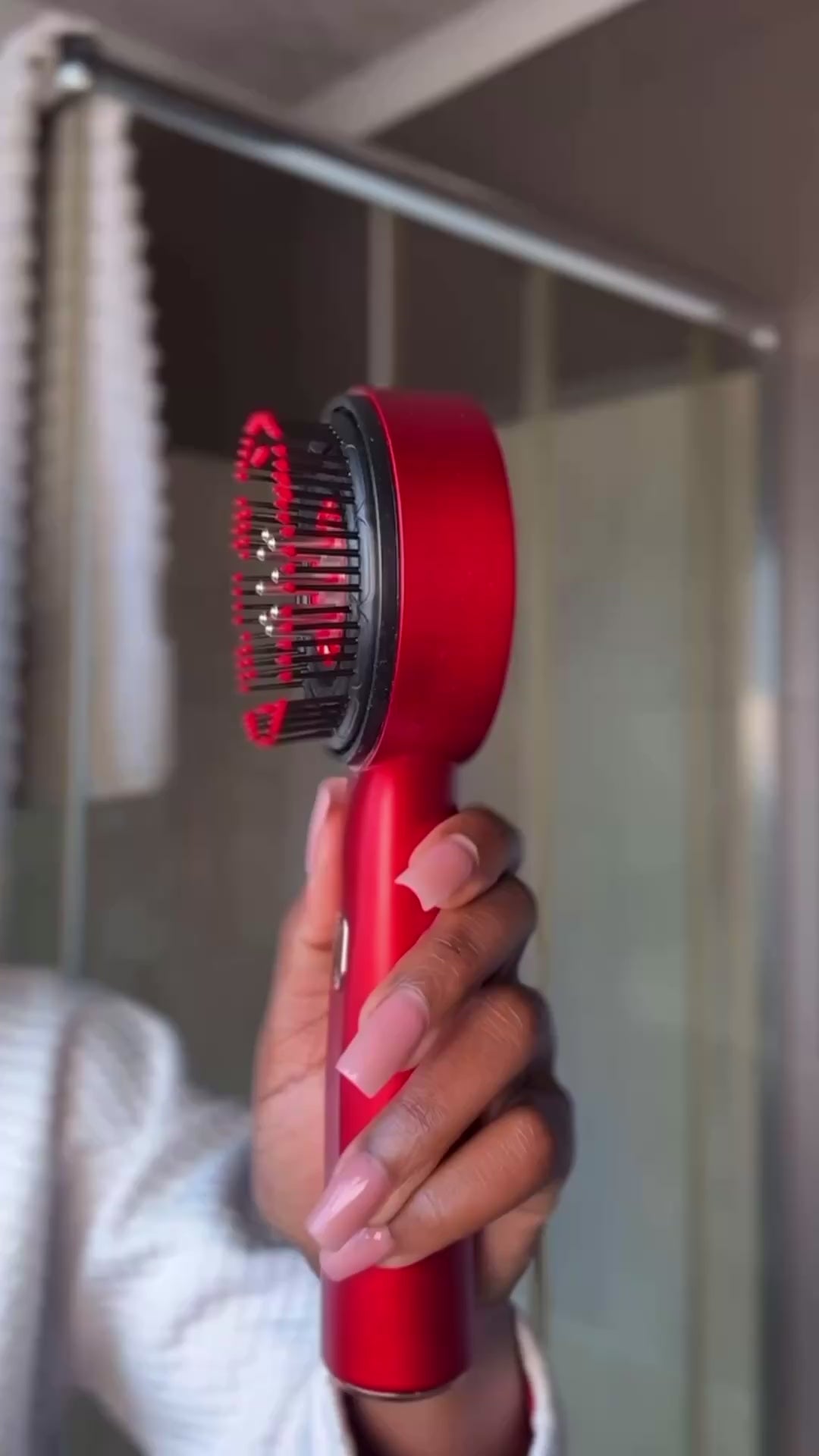 Woman using ScalpRevive Comb Pro red light therapy scalp massager for hair growth ritual